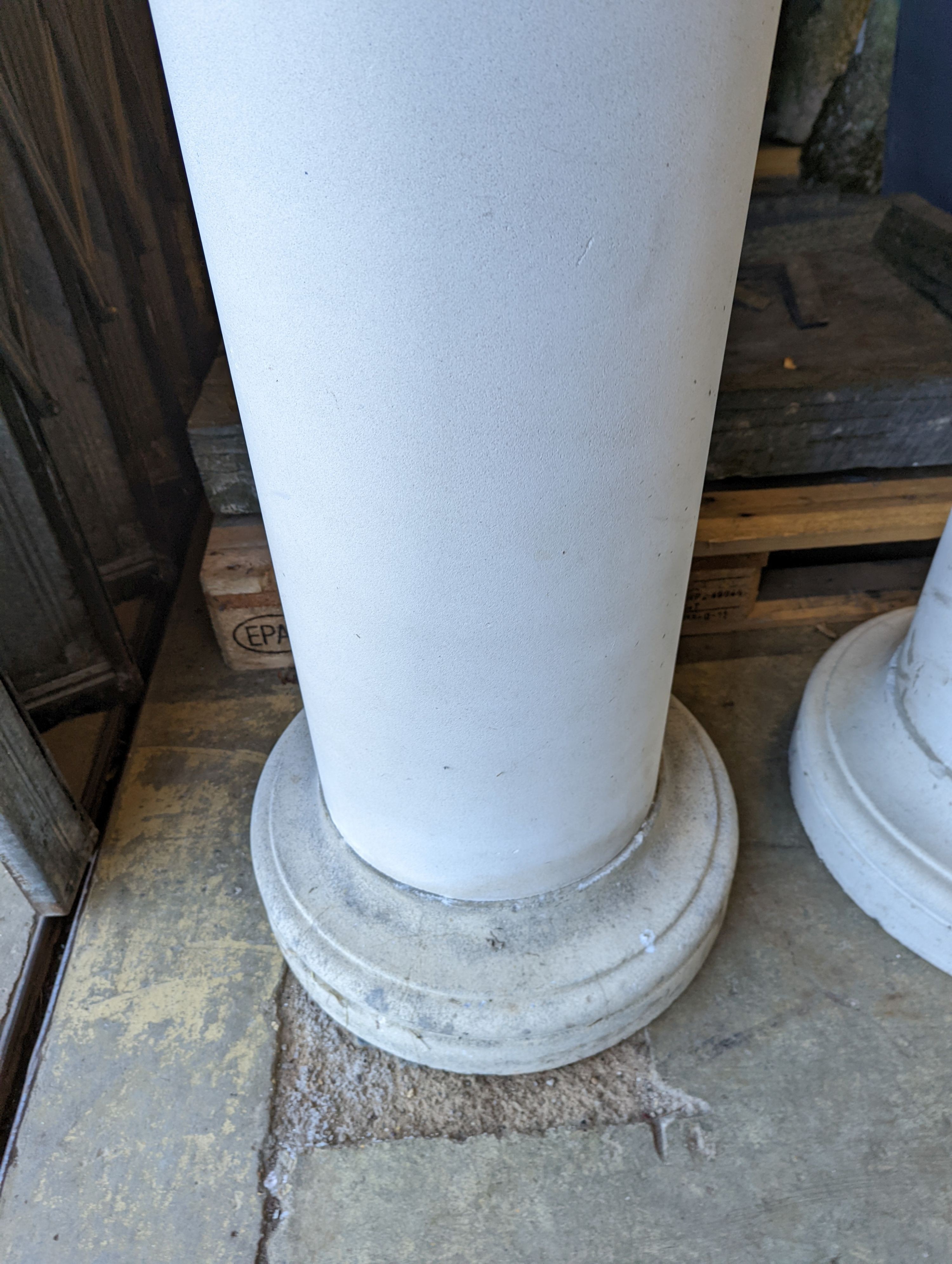 A pair of circular stone pedestals, tops 38cm diameter, height 99cm